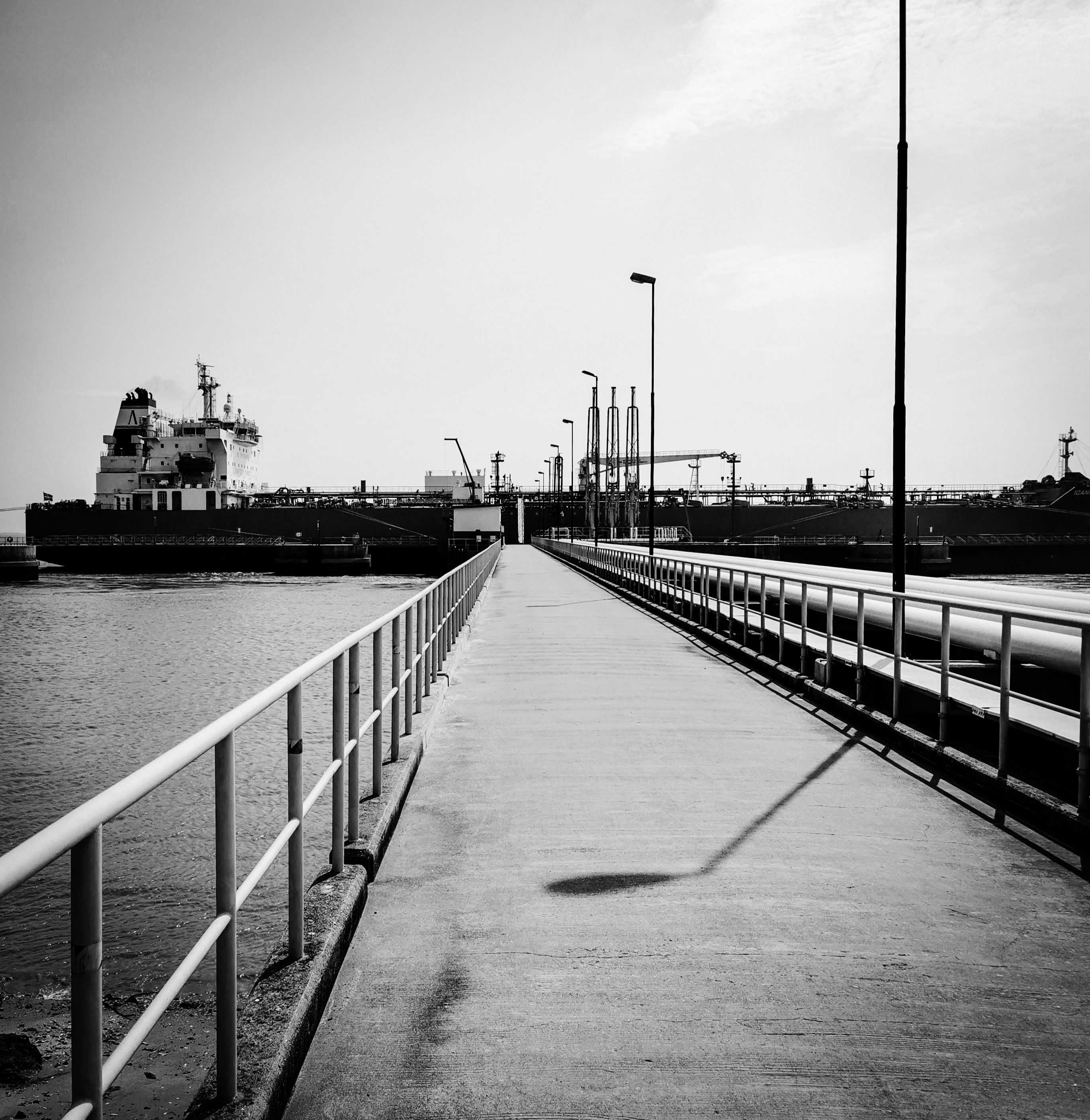 A jetty leading to tankers and pipelines at a fuel export terminal.