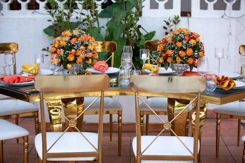 Chairs by a Table Decorated with Bouquets of Flowers