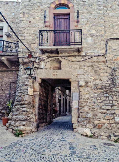 Free Explore the timeless stone architecture and narrow cobblestone streets of a Greek village. Stock Photo