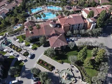 Stunning aerial view of a luxury resort with pools and lush greenery in Newport Beach, California.