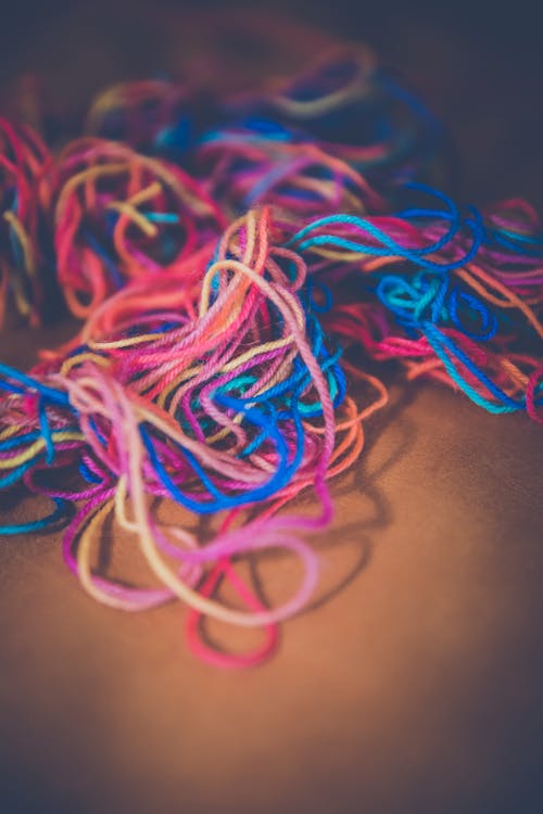 Free Blue and Red Thread on Brown Textile Stock Photo