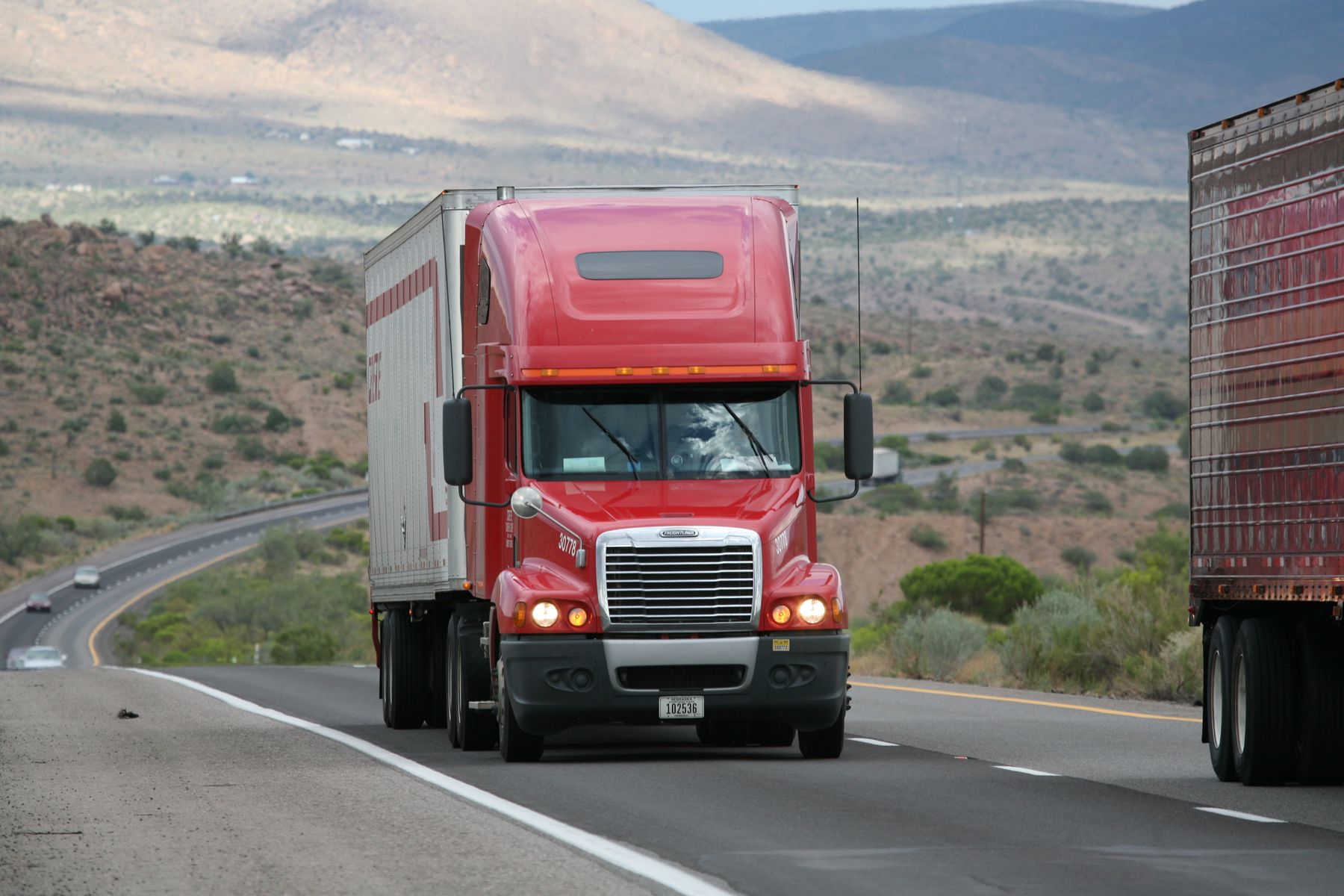 Red semi truck traveling on a United States highway