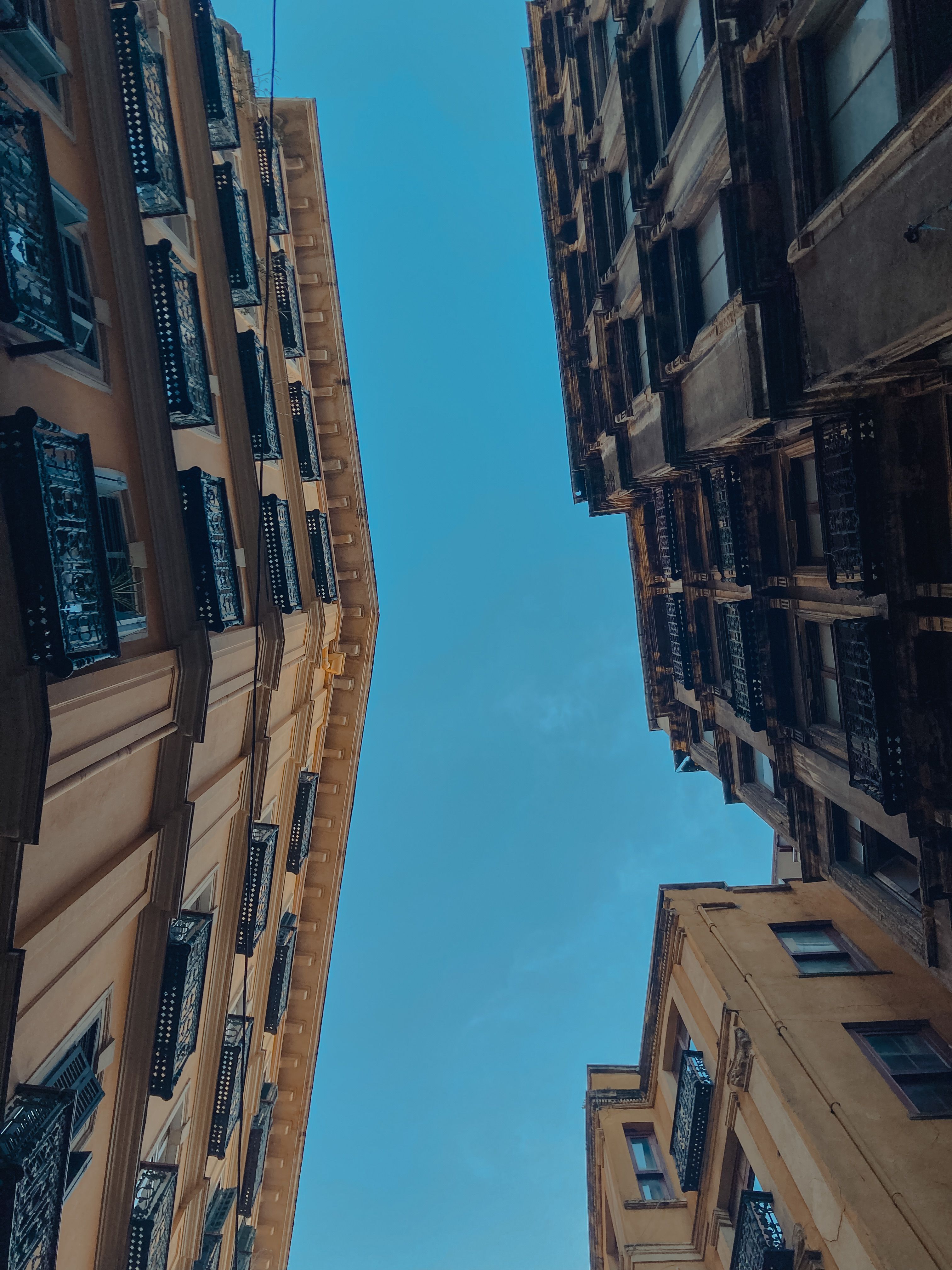 Low-Angle Shot of Concrete Buildings under the Blue Sky · Free Stock Photo