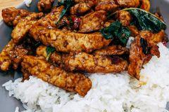Tasty Asian stir fry served with white rice, perfect for dinner.
