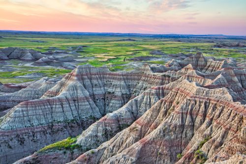Free Captivating sunset over the unique landscapes of Badlands National Park, South Dakota. Stock Photo