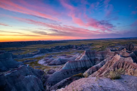 Badlands buttes glowing at sunset along the Loop Road