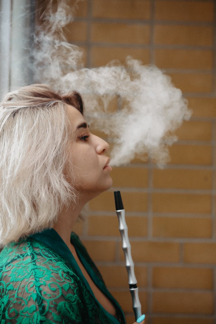 A Woman Smoking A Hookah