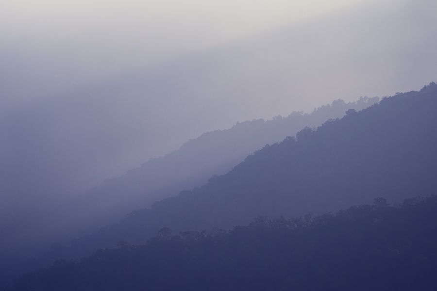 Blue mountain ridges under a foggy sky — photo by 6th Era Photography on Pexels