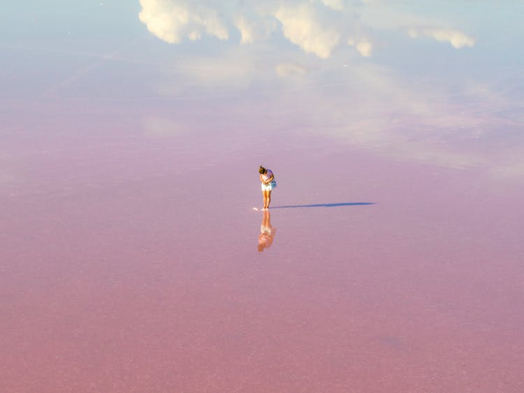 A Woman Standing On Pink Surface