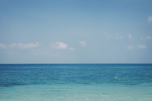 Peaceful ocean view with a clear blue sky and calm waters, perfect for relaxation and tranquility.