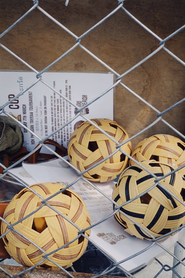 Sepak Takraw Balls Behind Chain Link Fence