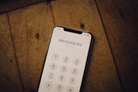 Close-Up Shot of a Mobile Phone on Wooden Surface