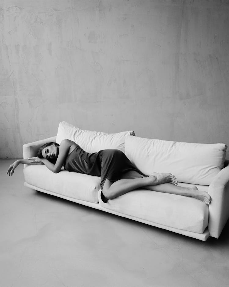 Woman In Dress Sleeping On Sofa