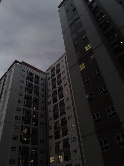 Free Dark urban cityscape with towering modern apartment buildings at twilight, showcasing architectural design. Stock Photo