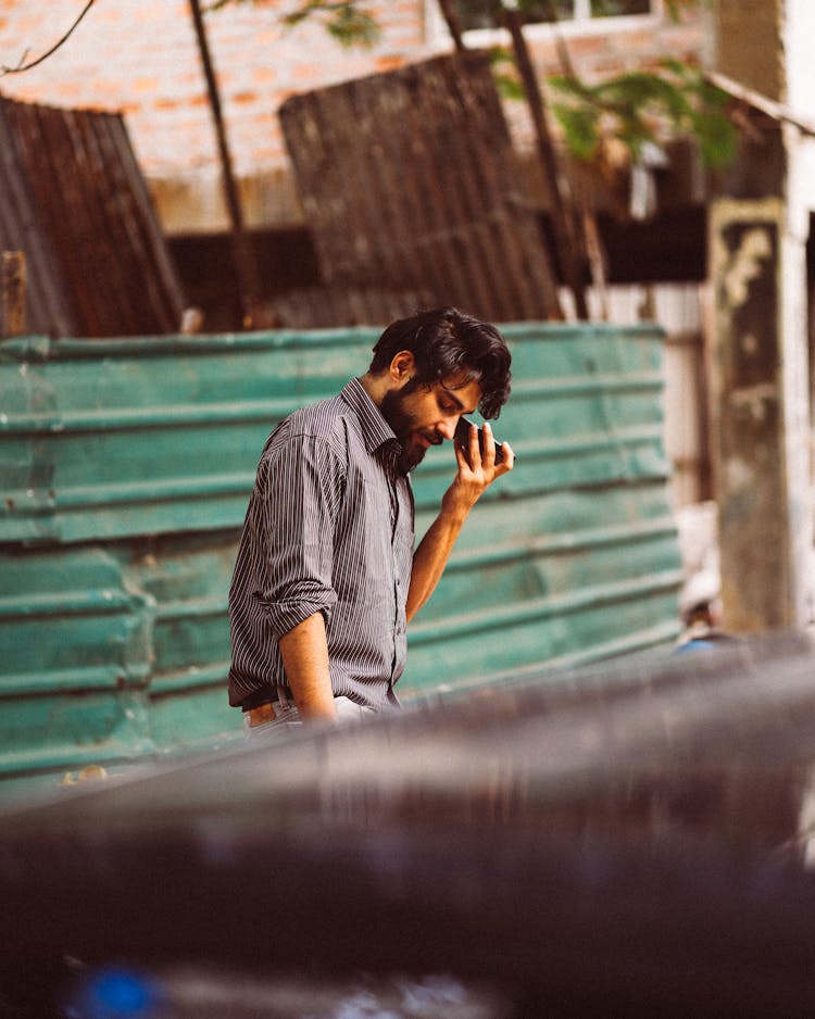 Bearded Man Holding A Cellphone