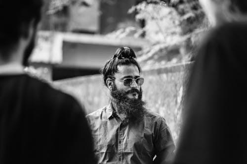 Monochrome Photo of a Man with a Bear Wearing Sunglasses