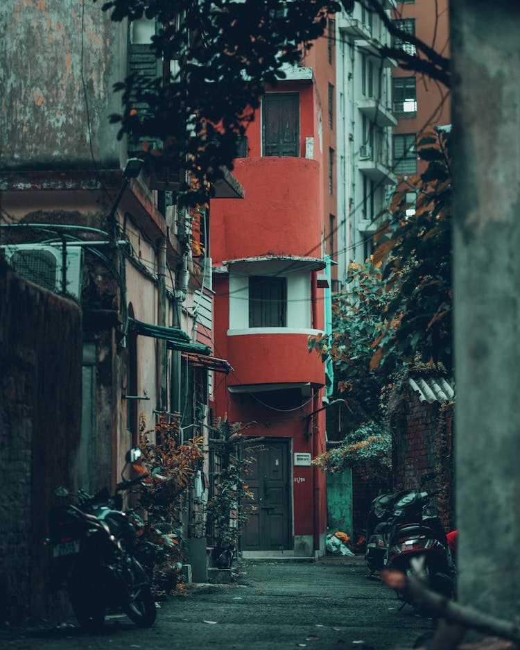 A Red Residential Building On The End Of Street