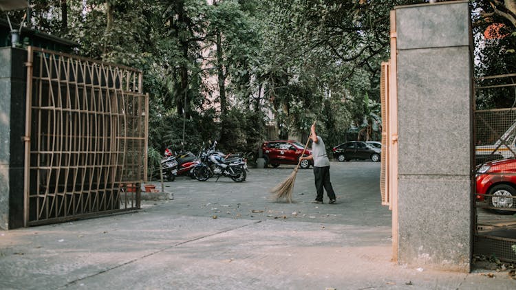 A Man Cleaning The Street