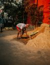 A Man Loading a Bucket with Sand