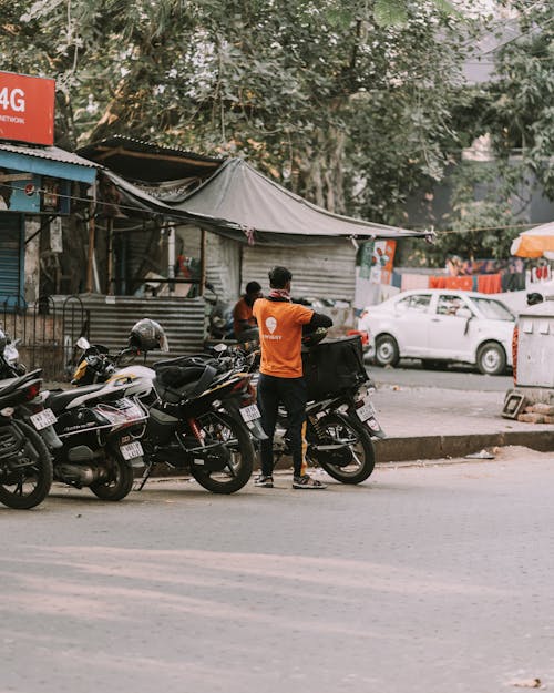 Man Standing next to Motorcycle 