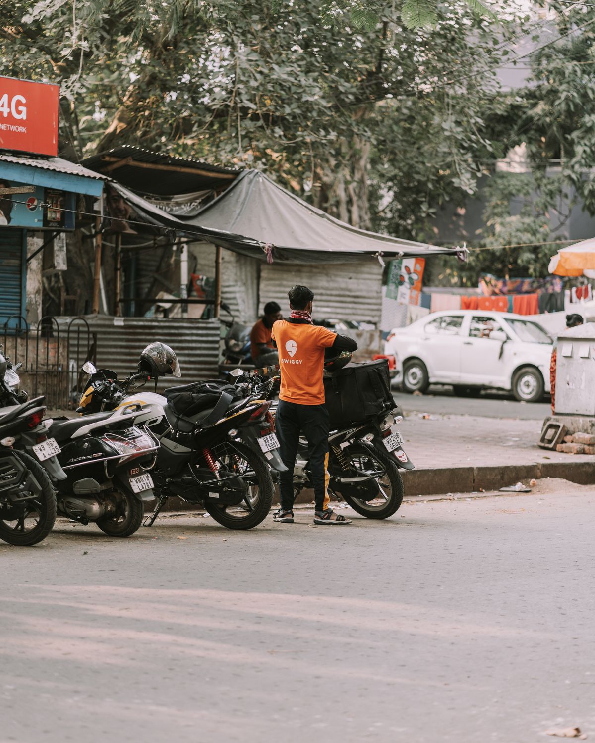 Motorcycles used for local delivery parked on an urban street