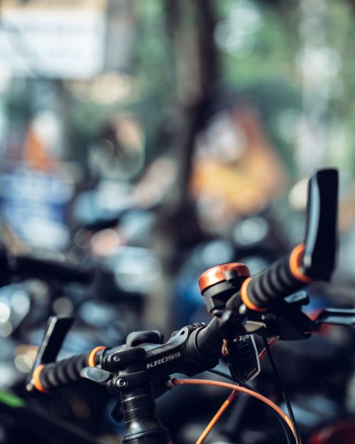Free Detailed shot of bicycle handlebars with a blurred Kolkata street market background. Stock Photo