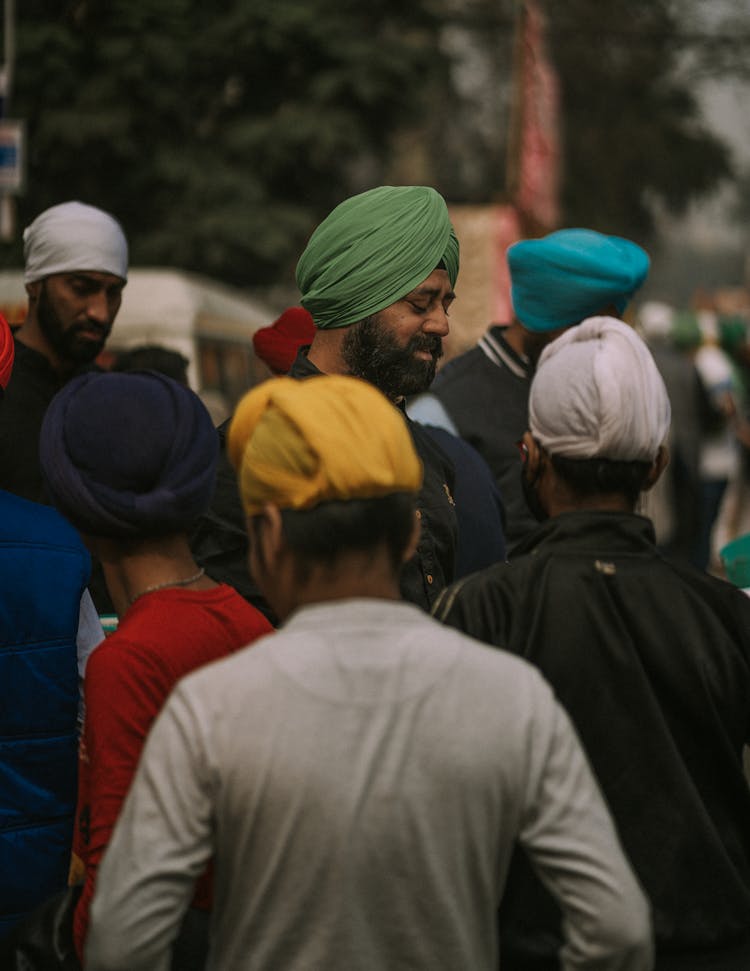 People Wearing Headscarves Standing On The Street