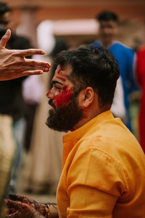 Man in Yellow Shirt with Face Paint