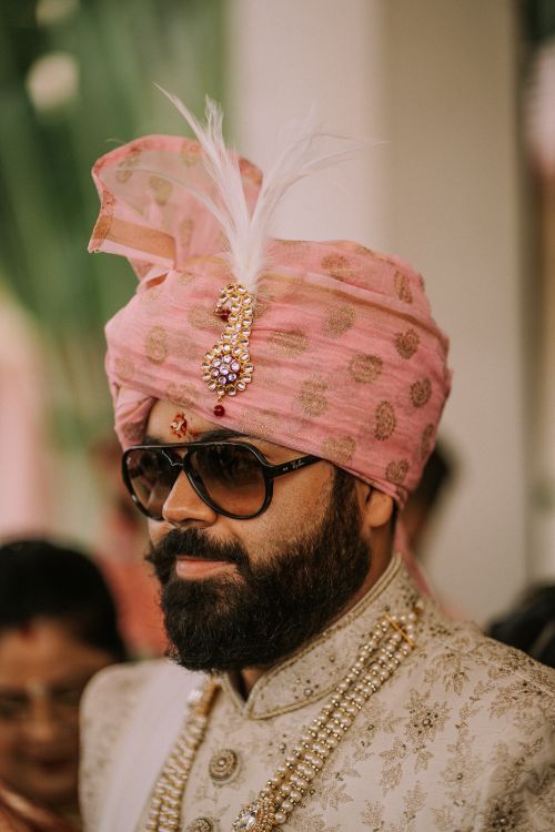Free A man wearing sunglasses and traditional Indian clothing with a pink turban. Stock Photo