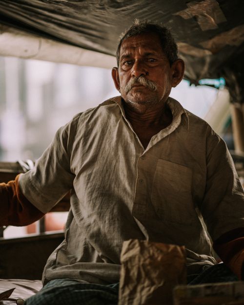 Free Portrait of senior man with mustache in urban location. Calm and pensive expression. Stock Photo