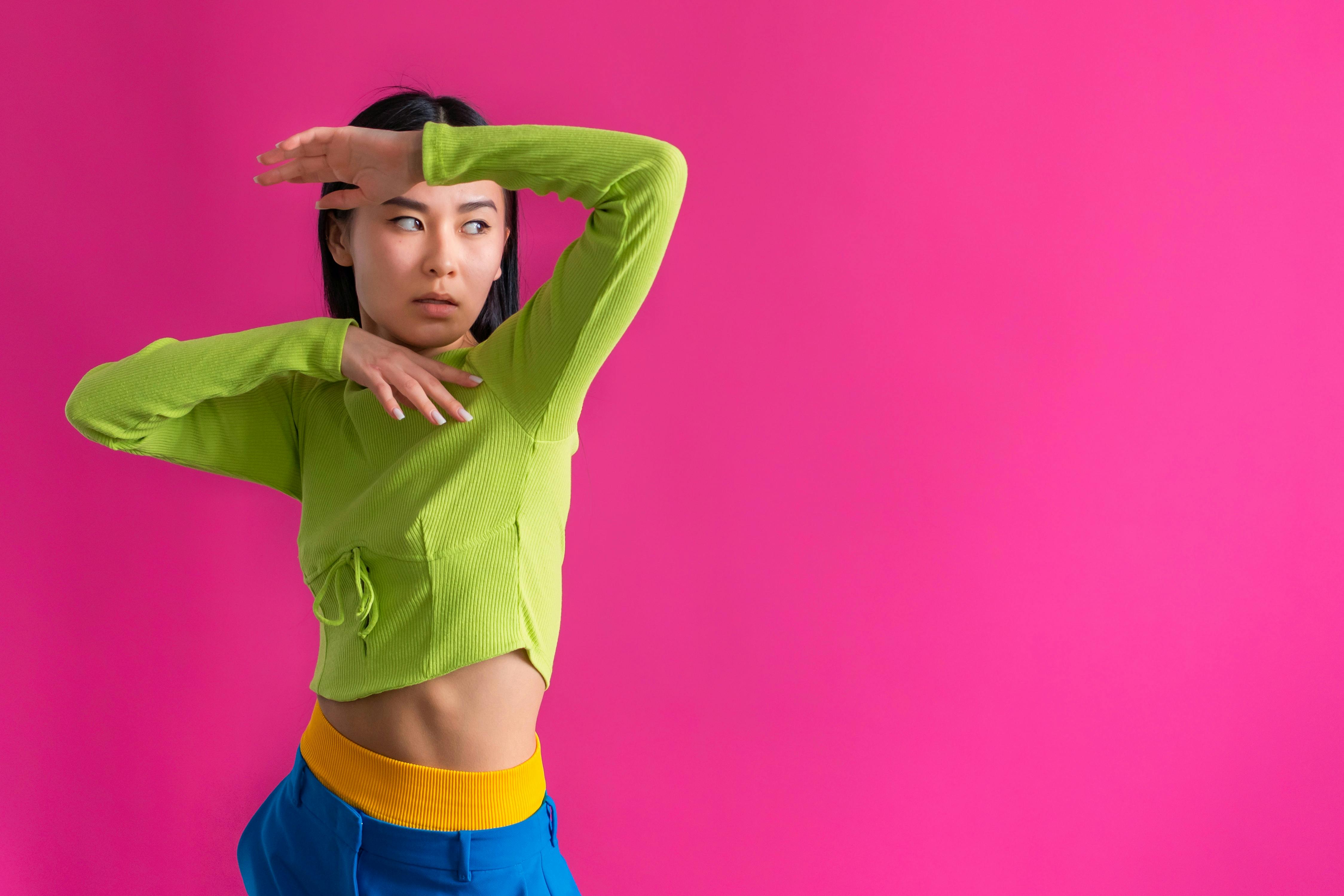 Woman in a Black Tank Top and Green Pants Posing · Free Stock Photo