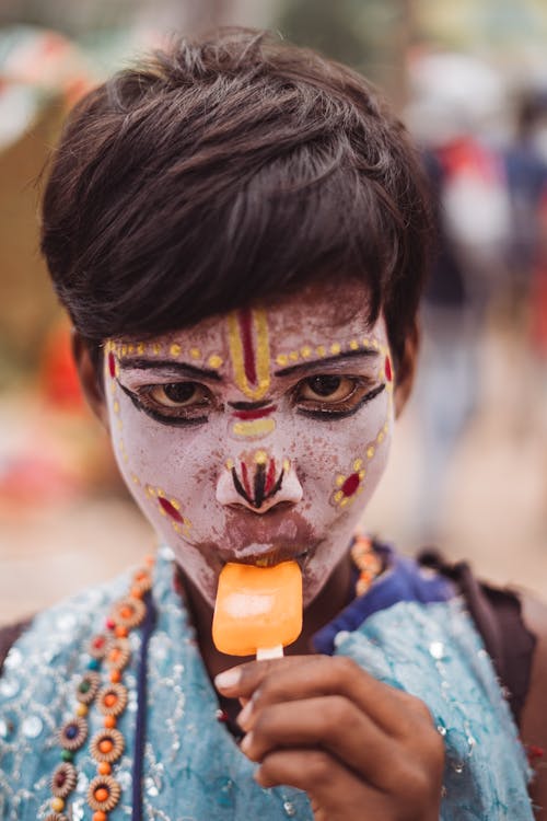 Free Boy with Face Paint Eating Ice Cream Stock Photo