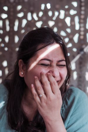 Woman laughing outdoors in warm light, photo by Rupinder Singh on Pexels