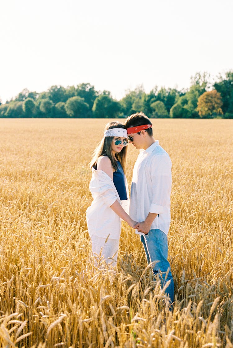 Couple Standing In Golden Wheat Field