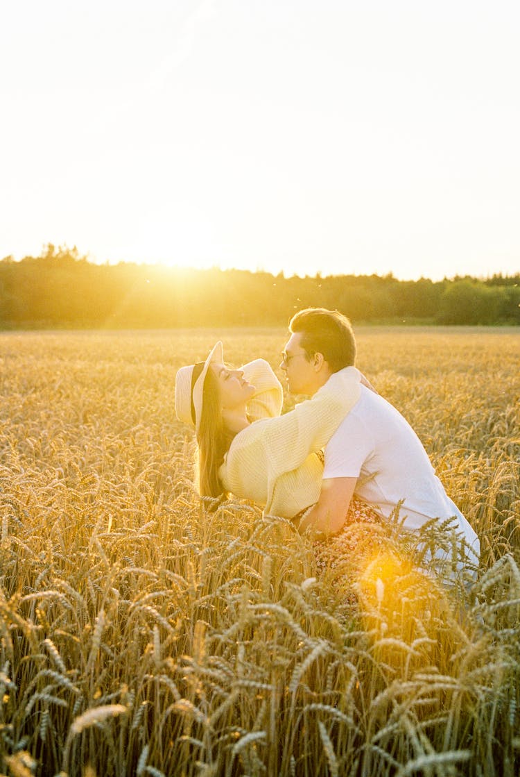 Man Hugging Woman On Field 