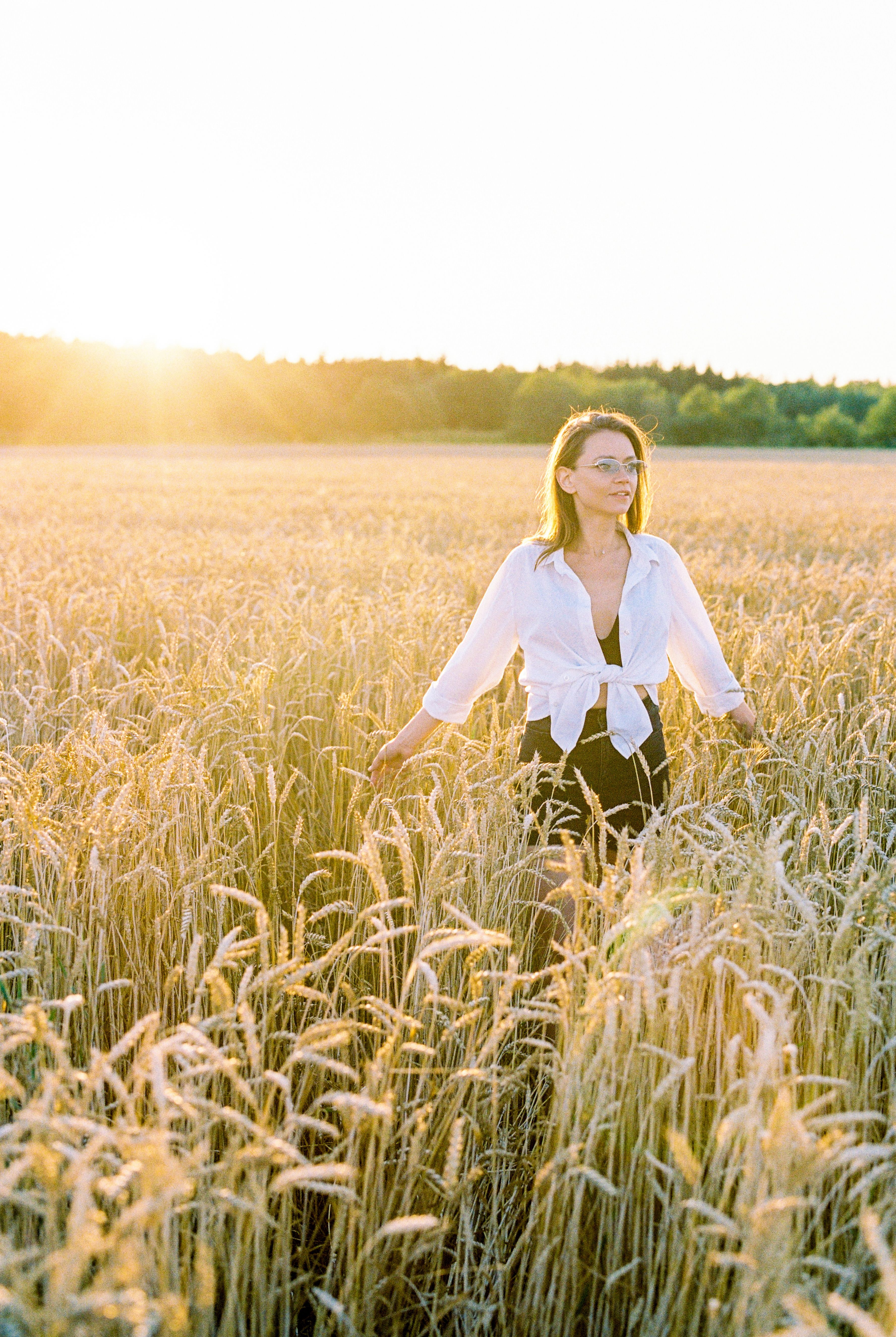 Woman in White Long Sleeves Standing on Wheat Field · Free Stock Photo