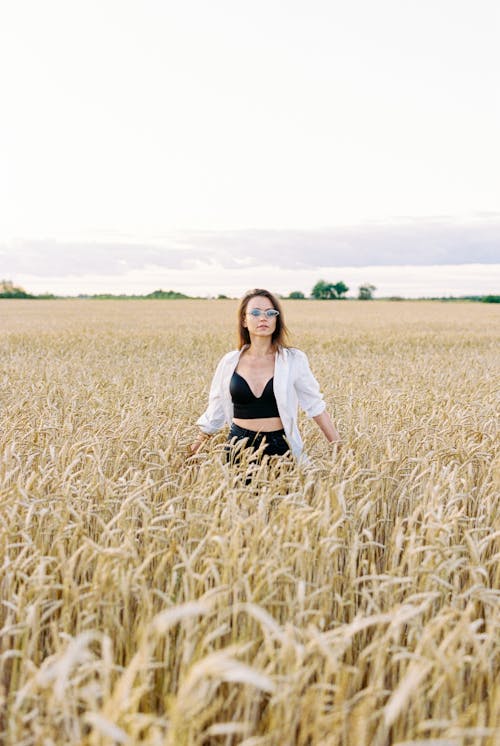 A Woman Standing on the Wheat Field 