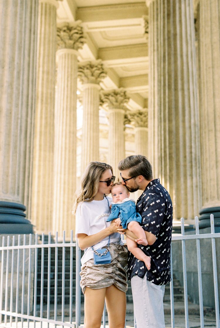 Couple Kissing Baby