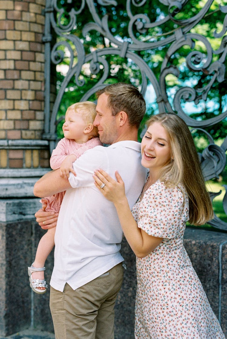 Smiling Mother And Father With Child