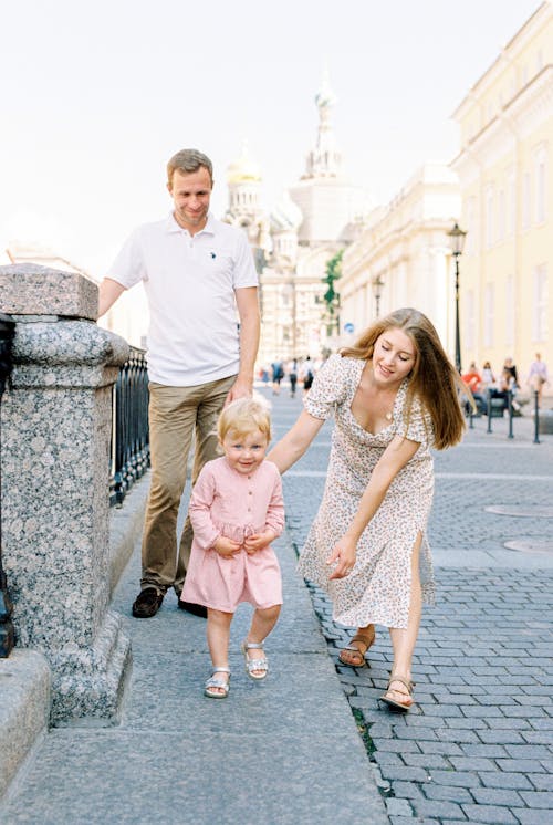 Free Parents Walking with Their Daughter Stock Photo