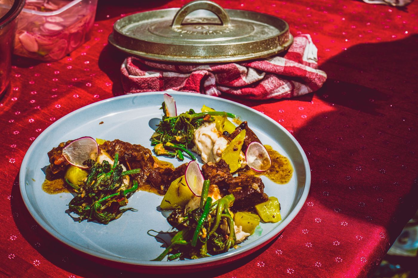 A delectable fusion meal plated artistically on a light blue plate showcasing vibrant colors and textures.