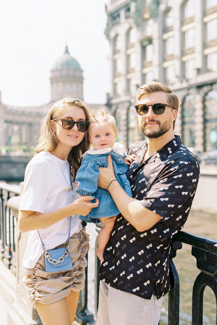 Adult Couple With Their Daughter On Trip In Old Town 