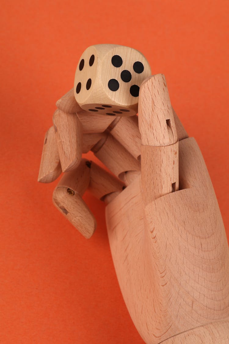 Wooden Hand Holding Dice