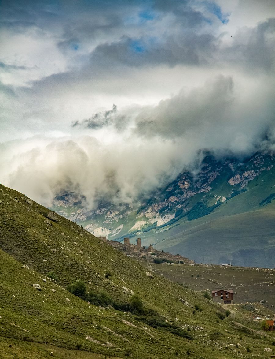 Green alpine valley under low clouds — photo by sharx _ on Pexels