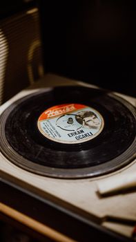Close-up of a vintage vinyl record spinning on a retro turntable.