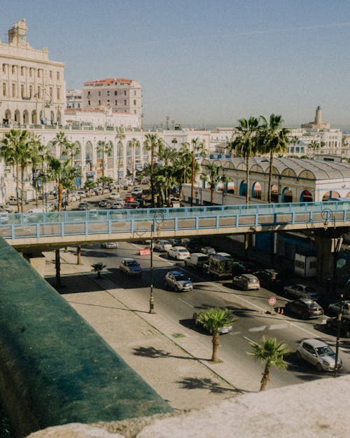 City Street Scene with Foot Bridge and Vehicles on Street