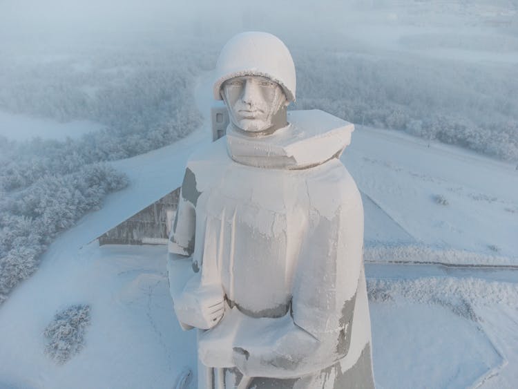 Snow Covering A Statue Of A Soldier In Winter 