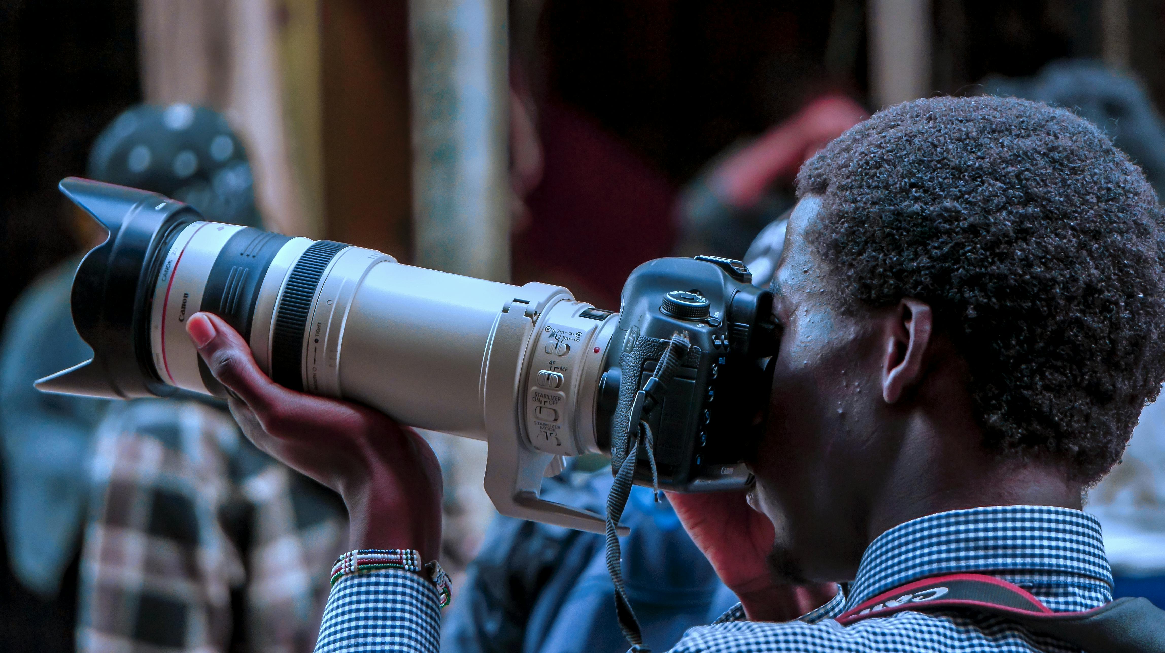 Close-up of a photographer capturing a shot in Nairobi, Kenya.