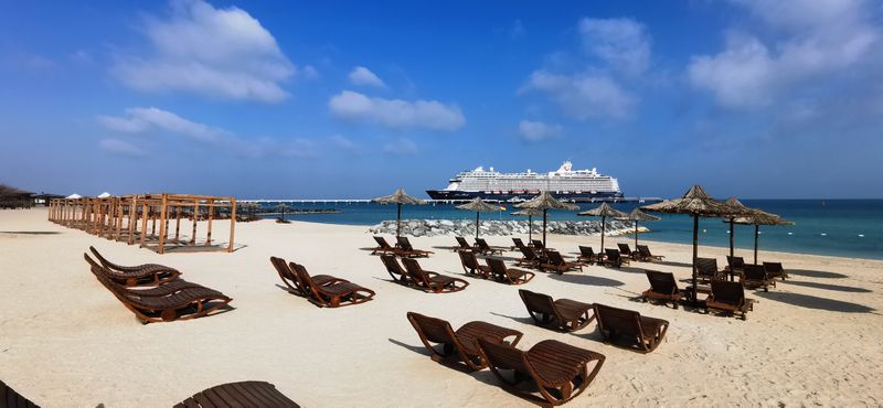 Sun loungers and beach huts on a Caribbean all-inclusive resort beach