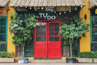 A Restaurant with Red Double Doors at the Entrance